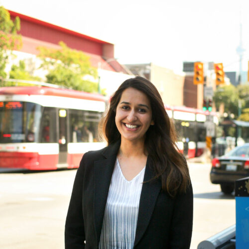 a person stands in front of a Toronto city scene